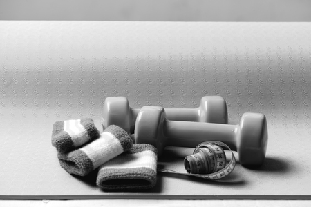 Shaping and fitness equipment. Dumbbells and measure tapeの写真素材
