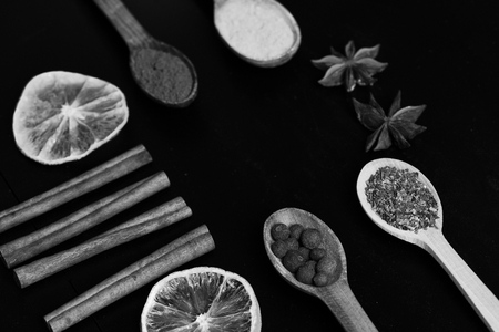 Set of spices on dark grey wood background. Composition of condiment, close up. Food art concept.の写真素材
