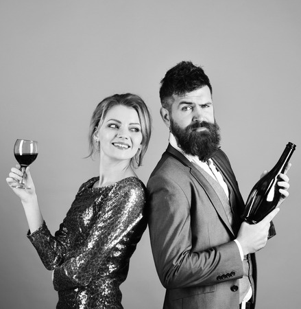 Winetasting and party concept. Couple in love drinks alcohol with smiling and tricky facesの写真素材