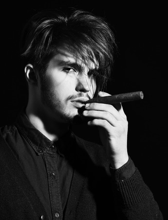 serious bearded man smoking cigarの写真素材