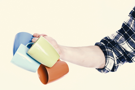 guy hand holding colorful cupsの写真素材
