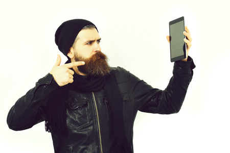 Bearded brutal caucasian hipster holding tabletの写真素材