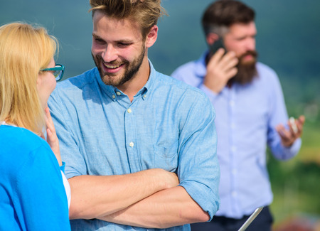 Couple having fun while busy businessman speak on phone. Couple flirting while man busy with mobile conversation. Husband losing wife because not pay attention to her. Flirt and love affair conceptの写真素材