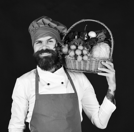 Vegetarian diet concept. Chef holds cabbage, radish, broccoli with lettuce and garlic.の写真素材
