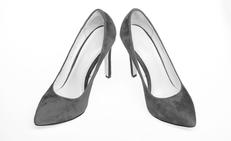 Footwear for women with thin high heels. Elegant stiletto shoes concept. Pair of fashionable high heeled pump shoes. Shoes made out of red suede on white background, isolatedの写真素材