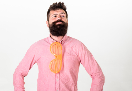 Man with beard and mustache on thoughtful face wear funny eyeglasses as tie, white background....