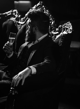 Bearded man with serious face and champagne glass.の写真素材