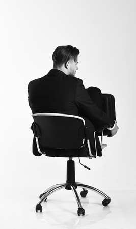 Businessman thinks about solutions isolated on white background. Man in smart suit looks for new ideas.の写真素材