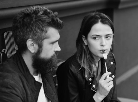 Woman and man with surprised faces have date at cafe.の写真素材