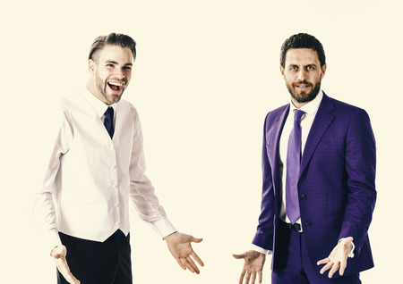 Business and relations concept. Men in formal wear or businessmen with smiling faces stands in confusion isolated on white background. Boss and employee or businessmen with confused expression.の写真素材