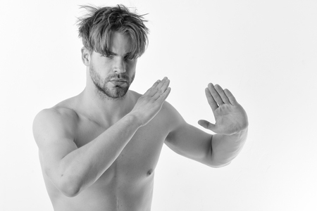 Man with confident face and bristle isolated on white background. Healthy lifestyle and jujitsu concept. Karate fighter with strong body practices martial arts. Guy poses in white kimono pants.の写真素材