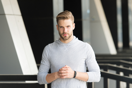 New technology and future innovations. Sportsman wear pedometer bracelet on hand on stadium. Fit man check workout results. What time is it. Technologies make training easier. Keeping eye on timeの写真素材
