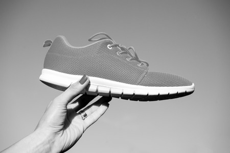 Sports shoes sneakers on blue sky background.の写真素材