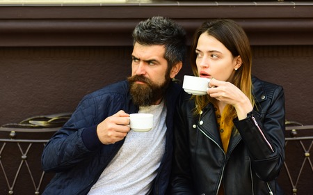 Love at urban cafeteria concept. Couple in love drinks espresso during coffee break. Woman and man...