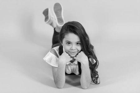 Small girl on floor on blue backgroundの写真素材