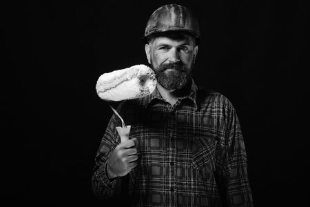 Man with happy face expression isolated on black background. Builder or painter with thick beard. Labour and repairing concept.の写真素材