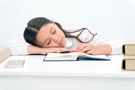 Nap concept. Tired schoolgirl have nap. Little girl taking nap at desk. It is a nap time