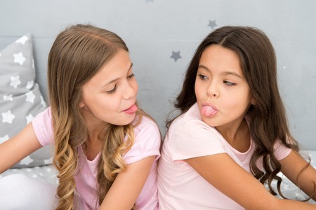 Children show tongue each other. Relations sisters or best friends. Overcome relations issues....