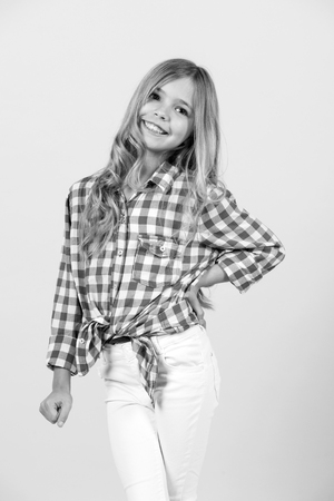 Happy girl child with long blond hair on orange background.の写真素材