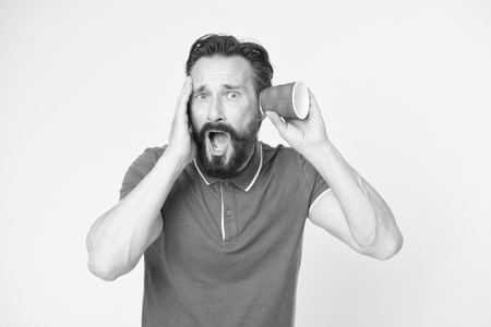 Man bearded mature guy eavesdrops with cup yellow background.の写真素材