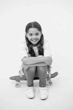 Happy girl sit on penny boardの写真素材