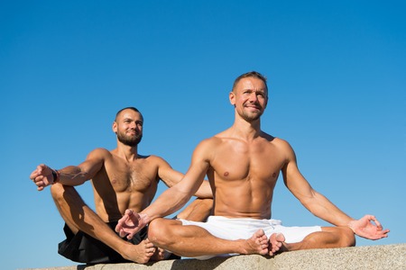 Men in yoga position.