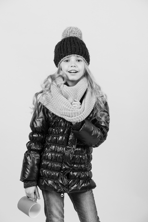 Child with blue cup smile on orange background. Autumn season relax concept.の写真素材