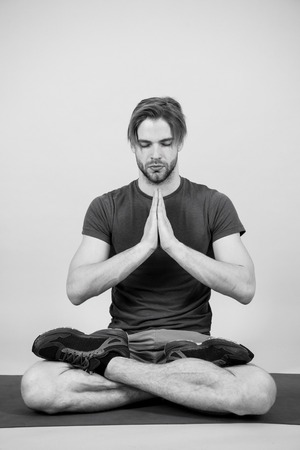 Man meditate on yoga mat, relax. Sportsman in lotus pose, meditation. Yoga, relax, meditation, zen, chakra lotus peace Sport fashion sportswear sneakersの写真素材