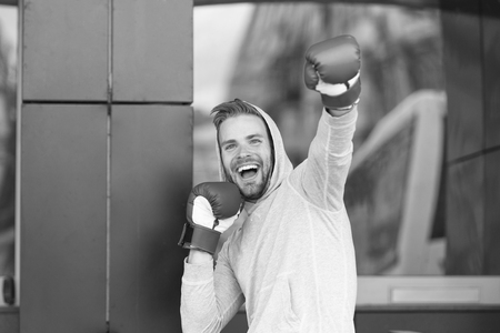 Man on smiling face posing with boxing gloves as winnerの写真素材