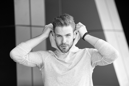 Guy bearded and attractive puts on hood.の写真素材