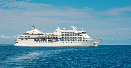 Large luxury cruise ship or liner on sea water and cloudy skyの写真素材