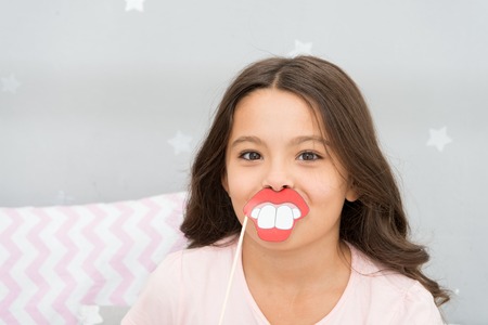 Kid girl cheerful posing with toothy mouth lips smile party attribute.の写真素材