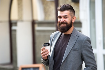 Drink it on the go. Man bearded hipster prefer coffee take away.の写真素材