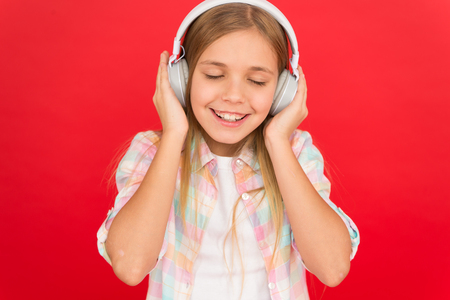 Girl child listen music modern headphones. Get music account subscription. Enjoy music concept. Music always with me. Little girl listen song headphones. Online radio station channel. Leisure concept.の写真素材