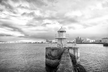 Lighthouse tower on stone pier in reykjavik, Iceland.の写真素材