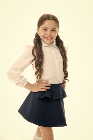 Little girl smile in school uniform isolated on white. Child smiling with long brunette hair. Fashion kid with stylish look. Beauty salon. Happy hair, happy you.の写真素材