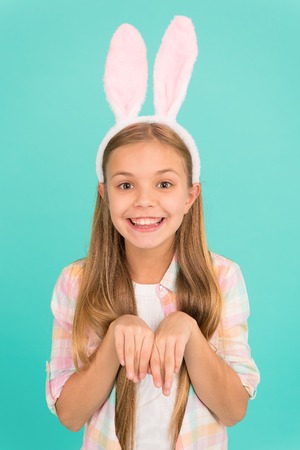 Traditions for kids to help get in easter spirit. Bunny ears accessory. Easter activities. Cute bunny. Holiday bunny girl posing with cute long ears. Child smiling play bunny role. Happy childhood.の写真素材