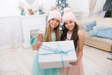Time to celebrate. delivery christmas gifts. happy little girls sisters celebrate winter holiday. christmas time. happy new year. little children girl with xmas present. Family holiday. Be positive.の写真素材