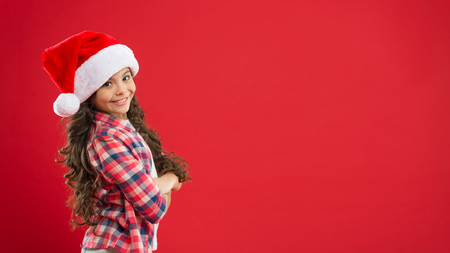 Christmas shopping. Little girl child in santa hat. Present for Xmas. Childhood. New year party. Santa claus kid. Happy winter holidays. Small girl. Preparing to Christmas. copy spaceの写真素材