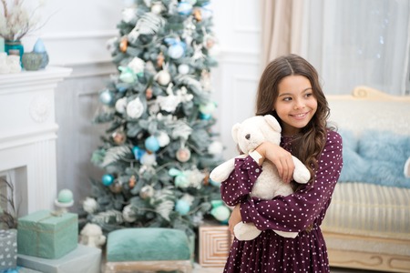 delivery christmas gifts. happy new year. happy little girl celebrate winter holiday. christmas time. Christmas together. Cute little child girl with xmas present. The whole world in one touch.の写真素材