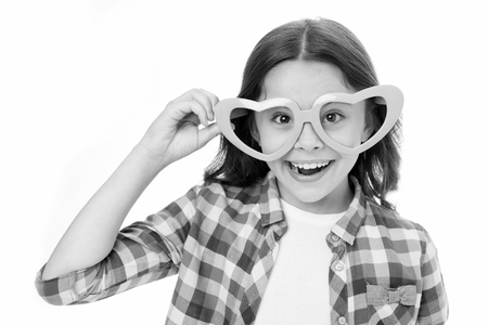 Sweet childhood. Kid happy lovely feels sympathy. Child charming smile isolated white background. Girl heart shaped eyeglasses celebrates valentines day. Girl adorable smiling face heart glasses.の写真素材