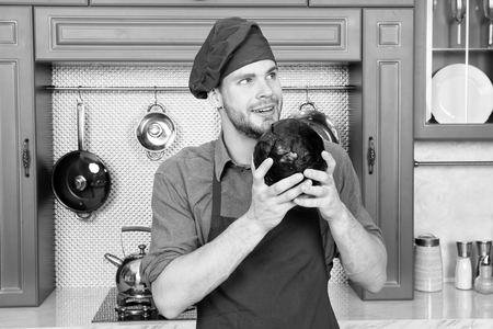 Remember recipe. Take old favorites and make healthful substitutions. Take favorite recipes and lighten them up. Man handsome chef holds violet cabbage thinking what healthy dish to cook.の写真素材