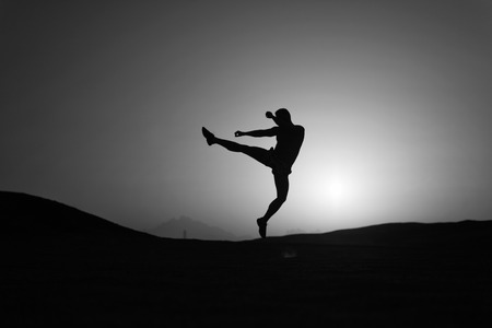Hit your goal. Silhouette man motion jump in front of sunset sky background. Daily motivation. Healthy lifestyle personal achievements goals and success. Future success depends on your efforts now.の写真素材