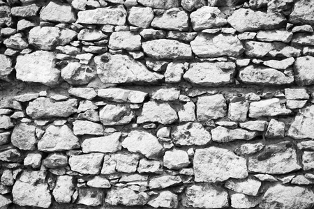 Old stony wall in Krakow texture background. Ancient background empty wall made out of stones in Krakow. Old building material concept. Ancient stony fortification or part of defenses.の写真素材