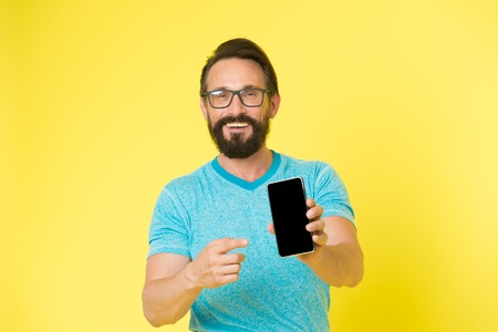 Update application. Hipster cheerful use smartphone. Man happy user of smartphone. Stay in touch with smartphone. Join online community. User friendly concept. Man excited about mobile opportunities.の写真素材