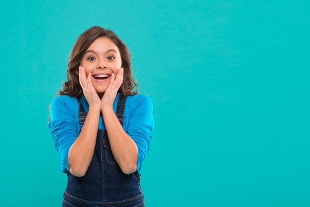 Childhood happiness. Happy little girl. Beauty and fashion. small kid fashion. International childrens day. small girl child with perfect hair. surprised child. copy space. Funky style beauty.の写真素材
