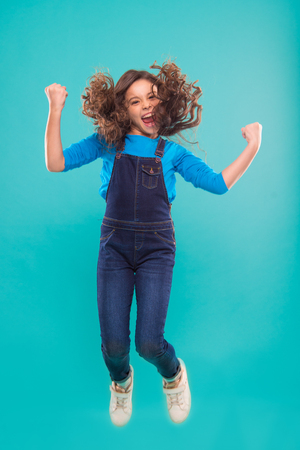 International childrens day. small kid fashion. small girl child with perfect hair. Happy little girl. Beauty and fashion. Childhood happiness. Add some action to your life.の写真素材