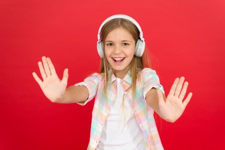 Little girl listen song headphones. Online radio station channel. Leisure concept. Girl child listen...