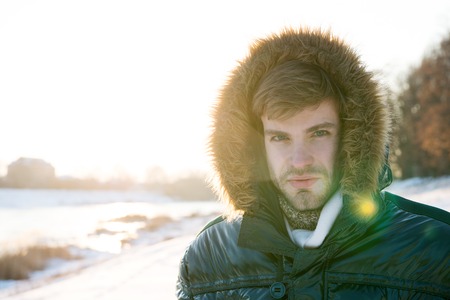 Vacation and traveling. Winter fashion. Warm clothes. Snowy weather. Trendy winter coat. Man. It is...