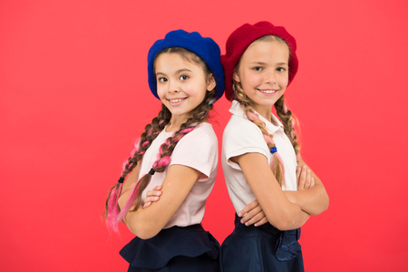 School fashion concept. Schoolgirls wear formal uniform and beret hats. Elite school college. Education abroad. Apply form enter international school. Sisters friends girls. French language school.の写真素材
